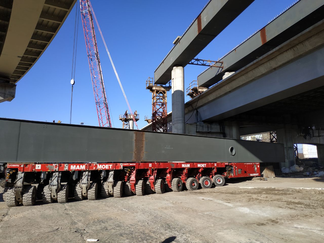 SPMT moving a steel bridge beam during bridge construction in Kyiv