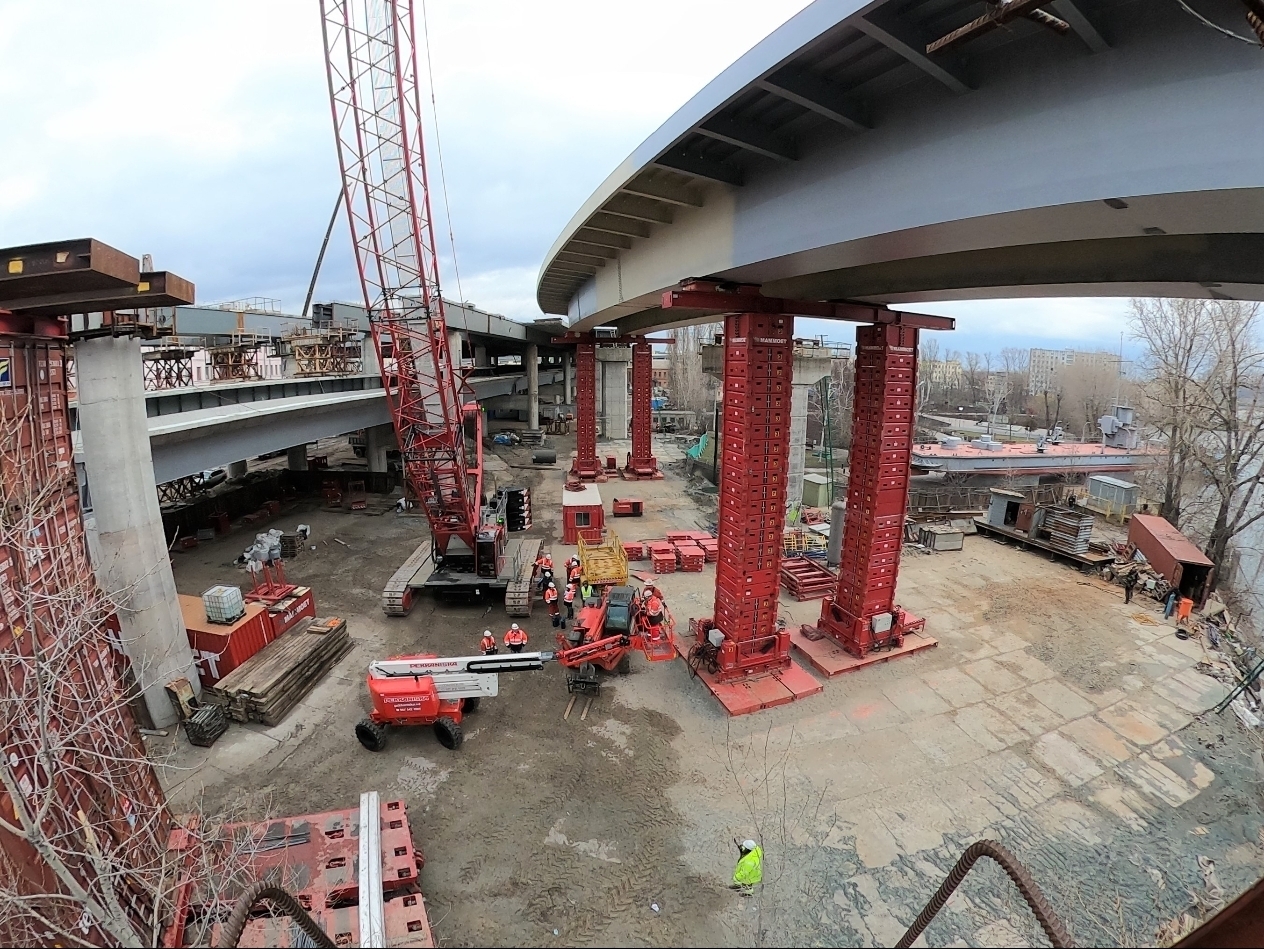 Hydraulic jacking towers beneath a major bridge structure in Kyiv
